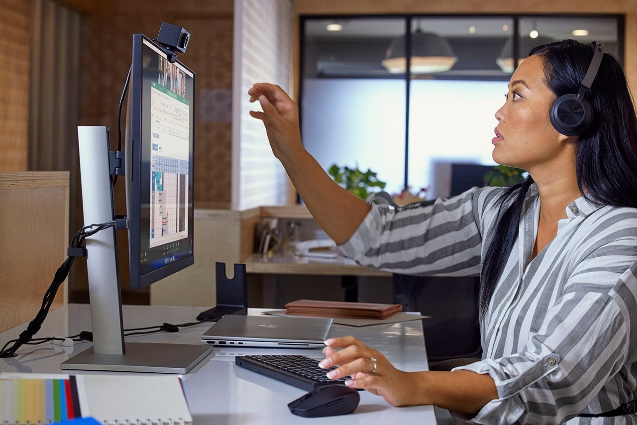 Woman where headpones and video chatting with others online