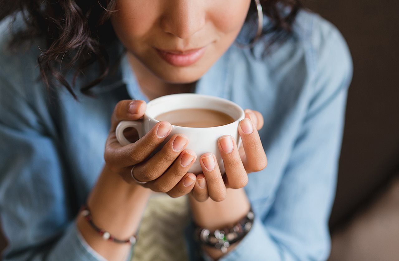 A woman holding a cup of coffee